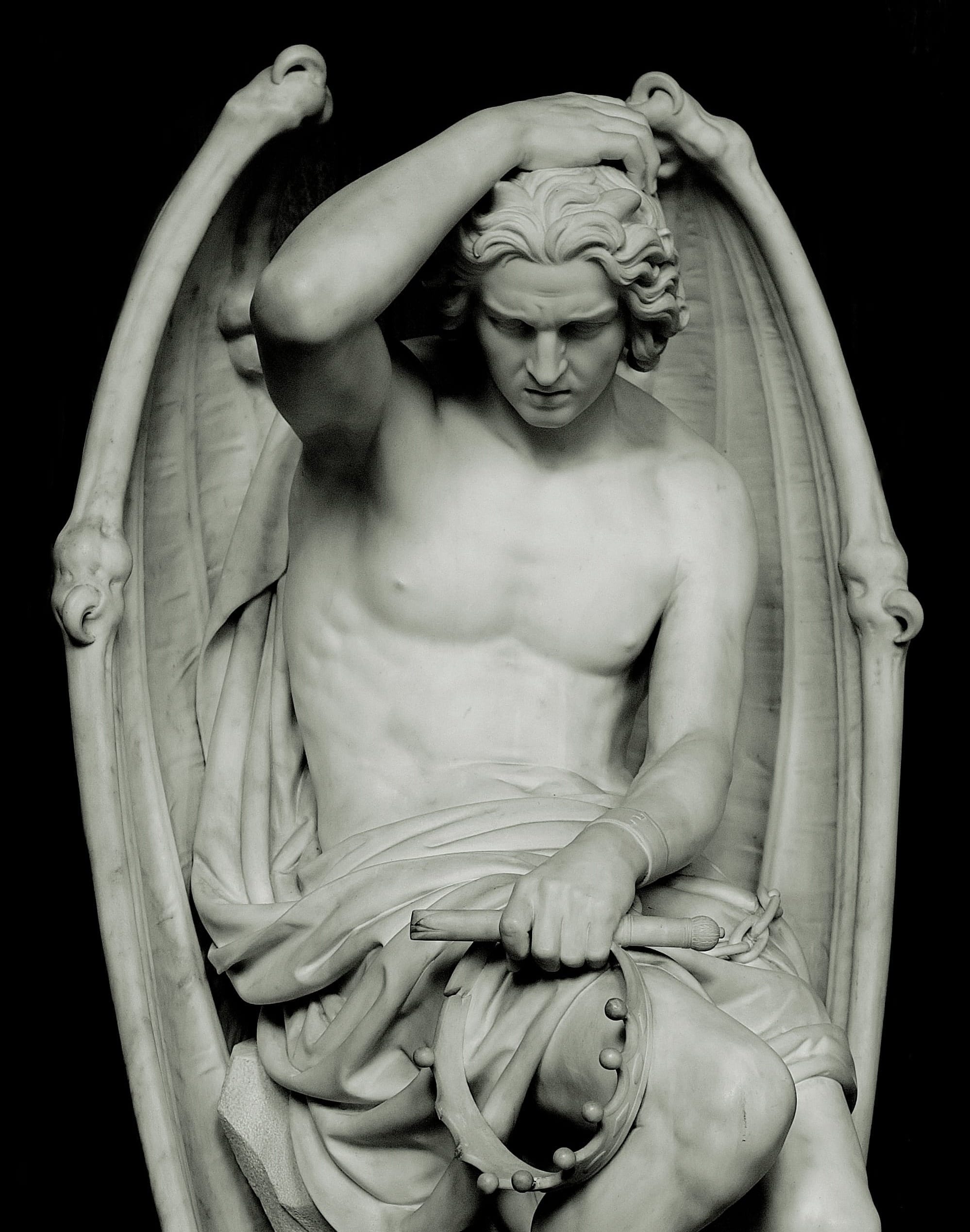 The marble statue clutches a broken crown, bows its head in despair, and a single tear runs down its cheek. Off screen is its shackled ankle. 